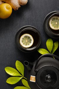 Layflat product photograph of an oriental hobnail teapot with lemon and ginger tea