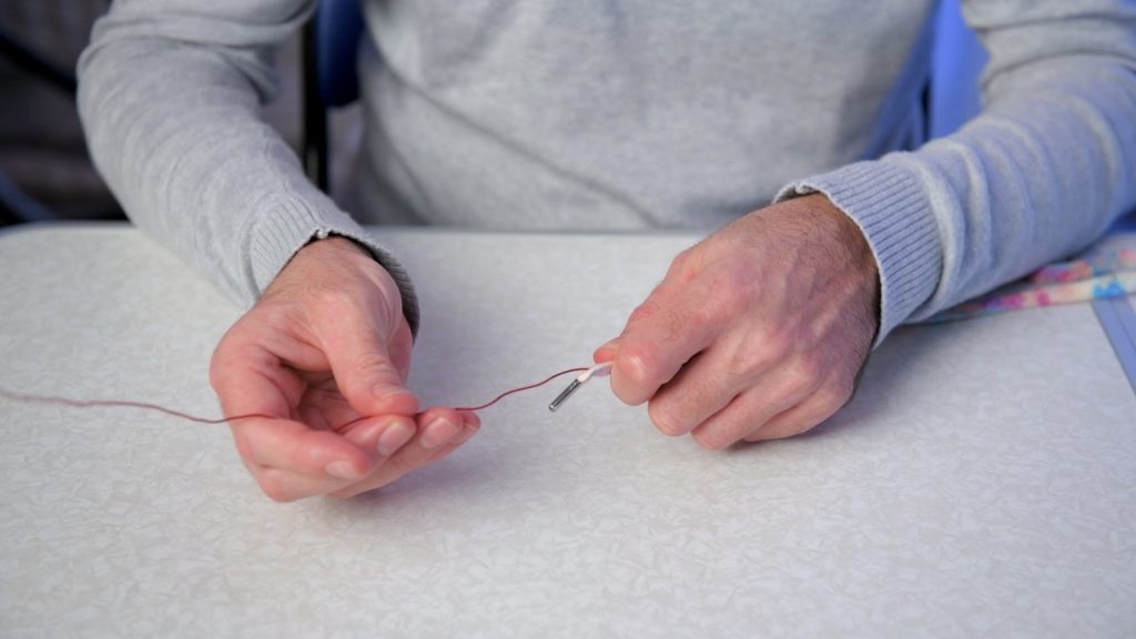 Showing how to push a piece of wire inside a lace to enable it to retain any shape desired.