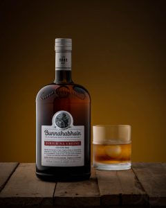 Product Photograph of a Whisky bottle in a rustic setting